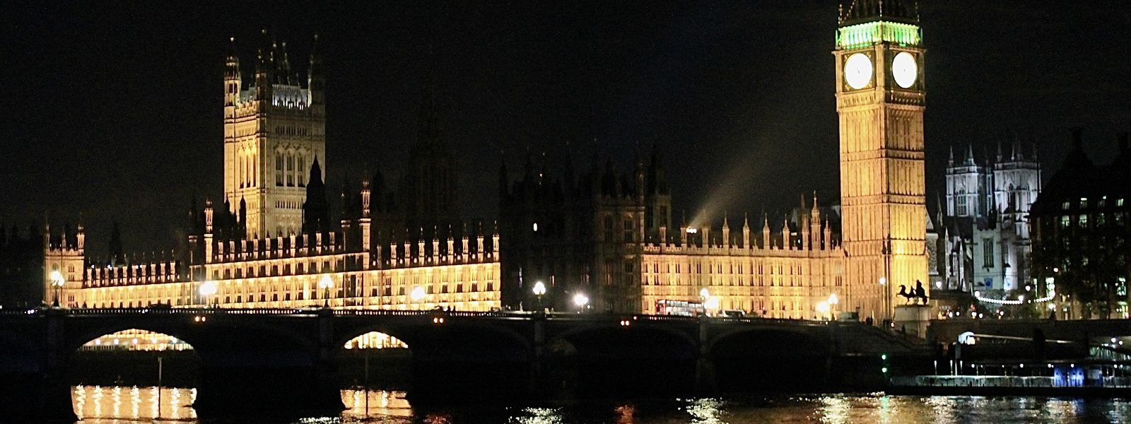 Palace of Westminster and Big Ben at night across the Thames